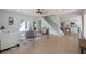 Bright and airy living room with wood floors, staircase and modern decor, perfect for comfortable living at 712 Maryland Ave, St Cloud, FL 34769