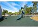 Playground with a blue slide, swings, climbing structure and benches with green mulch surface at 712 Maryland Ave, St Cloud, FL 34769
