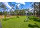 Recreational equipment on green astroturf surrounded by mature pines in community park at 712 Maryland Ave, St Cloud, FL 34769