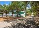 Picnic tables shaded by mature trees near the playground on a sunny day at 712 Maryland Ave, St Cloud, FL 34769