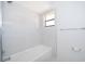 Updated bathroom with white subway tile, a tub with shower and natural light at 713 Coach Light Dr, Fern Park, FL 32730