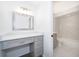 Bright vanity area connecting to updated white bathroom with tiled shower and modern finishes at 713 Coach Light Dr, Fern Park, FL 32730