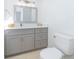 Bathroom featuring a grey vanity with double doors and modern hardware at 713 Coach Light Dr, Fern Park, FL 32730