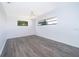 Bedroom with light grey wood floor, ceiling fan, and natural light at 713 Coach Light Dr, Fern Park, FL 32730
