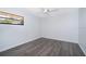 Bedroom with light grey wood floor, ceiling fan, and natural light at 713 Coach Light Dr, Fern Park, FL 32730