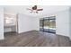 Neutral bedroom with gray wood-look flooring, ensuite vanity area, and screened patio access at 713 Coach Light Dr, Fern Park, FL 32730