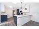 Bright kitchen with sleek two-tone cabinetry, stainless steel appliances, quartz countertops, and modern pendant lighting at 713 Coach Light Dr, Fern Park, FL 32730