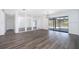 Large living room featuring stylish wood floors, updated lighting, and sliding doors to an outdoor patio or backyard at 713 Coach Light Dr, Fern Park, FL 32730