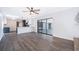 Open-concept living space with wood flooring, modern lighting, and seamless access to the updated kitchen and outdoor pool at 713 Coach Light Dr, Fern Park, FL 32730