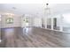 Spacious living area with wood floors, contemporary lighting, and French doors leading to a serene outdoor space at 713 Coach Light Dr, Fern Park, FL 32730