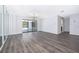 Bright living room featuring gray wood-look flooring and sliding glass doors to the outside at 713 Coach Light Dr, Fern Park, FL 32730