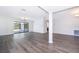 Bright and airy living area with wood floors, recessed lighting, a decorative column and sliding glass doors at 713 Coach Light Dr, Fern Park, FL 32730