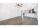 Open-concept living space with gray wood-look flooring leading to a modern kitchen with a skylight at 713 Coach Light Dr, Fern Park, FL 32730
