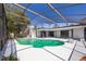 Screened-in pool area with a sparkling pool, spacious deck, and lush landscaping, perfect for outdoor enjoyment at 713 Coach Light Dr, Fern Park, FL 32730