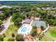 Lovely aerial view of the community pool and clubhouse with its manicured landscaping and recreational spaces at 717 Pine Ter, Altamonte Springs, FL 32714