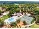 This high-angle shot features a pool and tennis court with nearby community clubhouse at 717 Pine Ter, Altamonte Springs, FL 32714