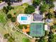Overhead view displaying community pool, clubhouse, and tennis courts enveloped by picturesque tree coverage at 717 Pine Ter, Altamonte Springs, FL 32714