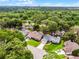 An aerial shot highlights a lovely suburban home surrounded by a canopy of trees in a Gathering-friendly neighborhood at 717 Pine Ter, Altamonte Springs, FL 32714