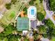Impressive aerial image displays a community pool, tennis court, and clubhouse with well-maintained landscaping at 717 Pine Ter, Altamonte Springs, FL 32714