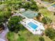 This aerial photo showcases a pool and tennis courts alongside the community clubhouse and beautiful landscaping at 717 Pine Ter, Altamonte Springs, FL 32714
