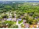 The aerial view reveals a serene neighborhood surrounded by lush greenery and mature trees at 717 Pine Ter, Altamonte Springs, FL 32714