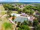 Gorgeous aerial view of community pool, tennis courts, and clubhouse surrounded by lush landscaping and trees at 717 Pine Ter, Altamonte Springs, FL 32714