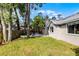 Backyard with lush green grass, garden, and a greenhouse at 717 Pine Ter, Altamonte Springs, FL 32714