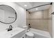 Bright bathroom featuring a white vanity, round mirror, and a tiled shower-over-tub with matte black fixtures at 717 Pine Ter, Altamonte Springs, FL 32714