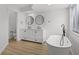 Spacious bathroom featuring a double vanity, free standing tub, and light wood-look floors at 717 Pine Ter, Altamonte Springs, FL 32714
