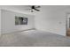 Neutral carpeted bedroom featuring a ceiling fan and a window overlooking the yard at 717 Pine Ter, Altamonte Springs, FL 32714