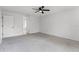 This carpeted bedroom has a ceiling fan and is accessible to the hallway and ensuite bathroom at 717 Pine Ter, Altamonte Springs, FL 32714