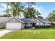 Charming single-story home with a well-maintained lawn and attached two-car garage at 717 Pine Ter, Altamonte Springs, FL 32714