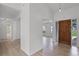 Inviting foyer with light wood-look floors and a striking wood front door at 717 Pine Ter, Altamonte Springs, FL 32714