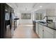 Modern kitchen with stainless steel appliances, sleek countertops, and white cabinetry at 717 Pine Ter, Altamonte Springs, FL 32714
