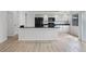Open kitchen featuring a breakfast bar with granite countertops and black appliances at 717 Pine Ter, Altamonte Springs, FL 32714