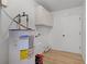 This laundry room has a water heater, overhead cabinets, and wood-look vinyl flooring at 717 Pine Ter, Altamonte Springs, FL 32714