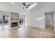 Bright living room featuring a stone fireplace, light wood-look floors and sliding doors at 717 Pine Ter, Altamonte Springs, FL 32714
