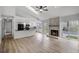 Open-concept living room and kitchen featuring stone fireplace and outdoor access at 717 Pine Ter, Altamonte Springs, FL 32714