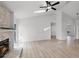 Bright living room featuring a stone fireplace, ceiling fan, and new floors at 717 Pine Ter, Altamonte Springs, FL 32714