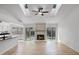 Bright and spacious living room featuring fireplace, skylight, and adjacent kitchen at 717 Pine Ter, Altamonte Springs, FL 32714