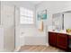 Bathroom featuring a soaking tub, a glass-enclosed shower, and a vanity with a sink and storage at 7978 Sea Pearl Cir, Kissimmee, FL 34747