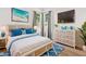 Well-lit bedroom with coastal decor, a TV, and comfortable furnishings creating a cozy and inviting space at 7978 Sea Pearl Cir, Kissimmee, FL 34747