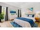 Staged bedroom with a bed, ocean-themed artwork, and a matching blue rug creates a cozy atmosphere at 7978 Sea Pearl Cir, Kissimmee, FL 34747