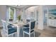 Bright dining room features a modern table with seating for six, elegant lighting and decor with a coastal vibe at 7978 Sea Pearl Cir, Kissimmee, FL 34747