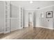 Clean and spacious room with hardwood flooring, built-in shelving, and neutral paint ideal for customization at 7978 Sea Pearl Cir, Kissimmee, FL 34747