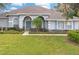 Charming single-story home features a well-manicured lawn, lush landscaping, and a welcoming entrance at 7978 Sea Pearl Cir, Kissimmee, FL 34747