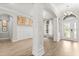 Open-concept living room features elegant architectural details, light wood floors, neutral paint and lots of natural light at 7978 Sea Pearl Cir, Kissimmee, FL 34747