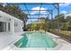 Screened-in pool area with blue skies above and a spacious deck perfect for entertaining and relaxation at 7978 Sea Pearl Cir, Kissimmee, FL 34747