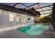 Relaxing backyard pool area with string lights, covered patio, ceiling fan, and outdoor TV at 7978 Sea Pearl Cir, Kissimmee, FL 34747