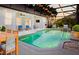 Enclosed pool area with string lights, comfortable seating, and lush landscaping creating a relaxing outdoor space at 7978 Sea Pearl Cir, Kissimmee, FL 34747